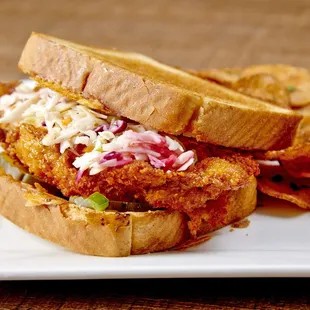 Nashville Hot Chicken - Spicy fried chicken with coleslaw, pickles, Carolina BBQ sauce served on cheddar parmesan Texas toast.