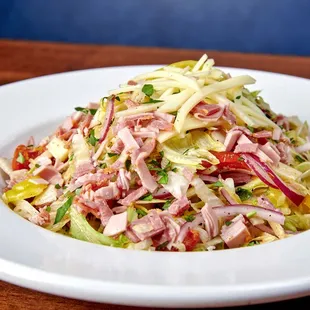 a plate of salad on a wooden table