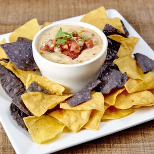 Chori-Queso - Melted Oaxaca and Pepper Jack cheese, topped with chorizo and fresh pico de gallo. Served with mixed corn tortilla chips.
