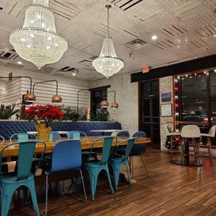 a dining room with a long table and blue chairs