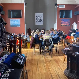 a group of people sitting at tables in a restaurant