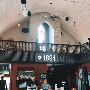 the inside of a restaurant with a clock on the wall