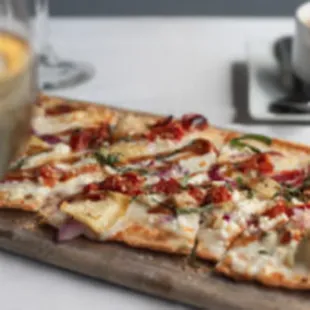 a pizza and a glass of wine