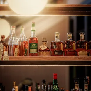 a shelf full of liquor bottles