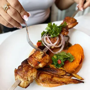 Our "Mangal" Chicken Skewers Tender Chicken Thighs Marinated in Grandma's Secret Spice Mix, Served With Roasted Tomato Tahini &amp; Grilled Vege