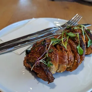 a piece of steak on a plate with a fork and knife