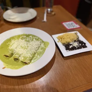 ENCHILADAS de HUITLACOCHE with side of rice and beans.
