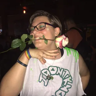 a woman with a rose in her mouth