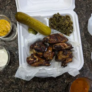 Smoked to go wings with greens and my sauces with spicy pickle!