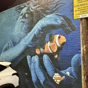 a car parked in front of a painted mural