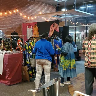 a group of people shopping in a clothing store