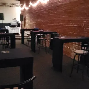 the interior of a restaurant with tables and chairs