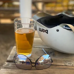 a glass of beer and a helmet