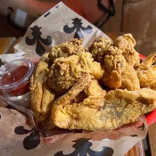 a basket of fried fish and fries