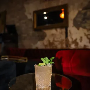 a cocktail on a table in a dimly lit room