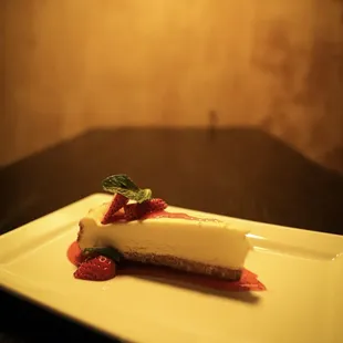a piece of cheesecake with strawberries on a plate