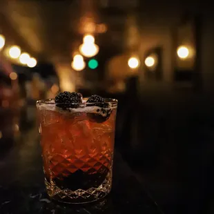 a drink in a glass on a bar counter