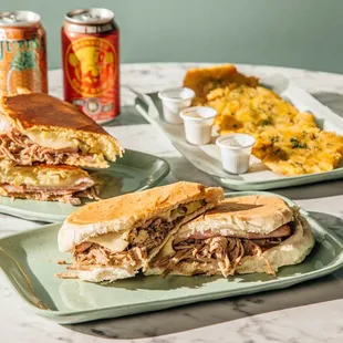 two plates of sandwiches and a can of beer