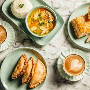 Empanadas, pastries, chicken soup, white rice, cafe con leche