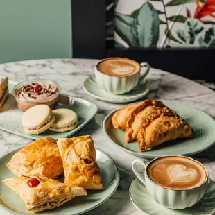 Cafe con leche, empanadas, assorted desserts