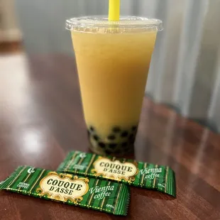 a cup of bubble tea and two packets of bubble tea