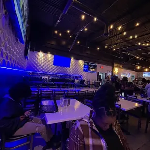 people sitting at tables in a restaurant