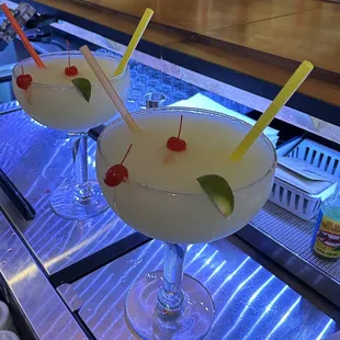two cocktails on a bar