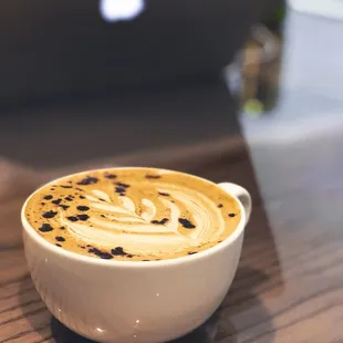 a cup of cappuccino on a table
