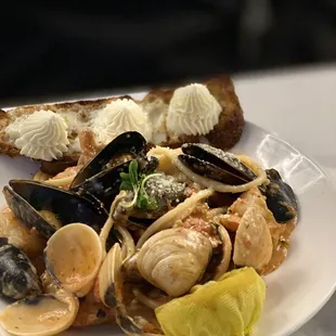 Seafood cioponin pasta with ricotta cheese toast sourdough