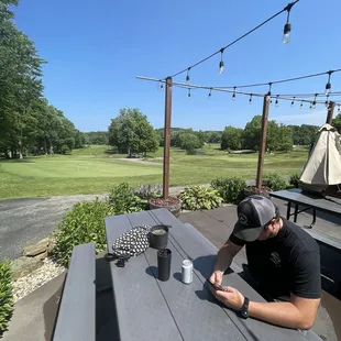 a man sitting at a picnic table