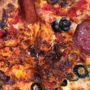 Overcooked, burnt and areas of no toppings.