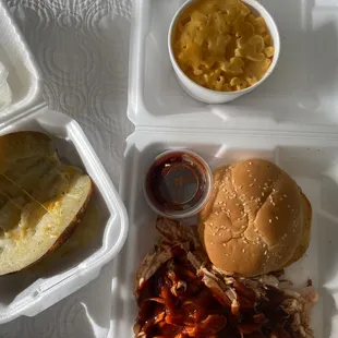 Pulled chicken with their hot bbq sauce , Mac &amp; cheese and a baked potato