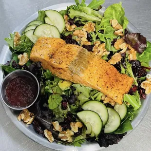 a plate of salad with salmon