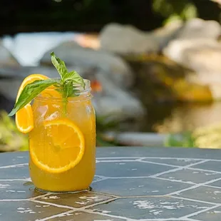 a glass of orange juice on a table
