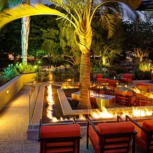 a patio with a fire pit