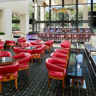 a restaurant with red leather chairs