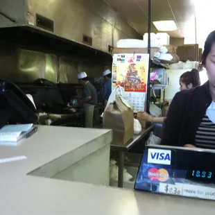 The entire cooking area is fully visible from the counter. A staff of older Asian men who have been making great food for years!