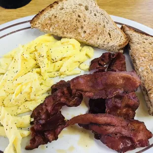 2 scrambled eggs with wheat toast and crispy bacon . Made like I requested