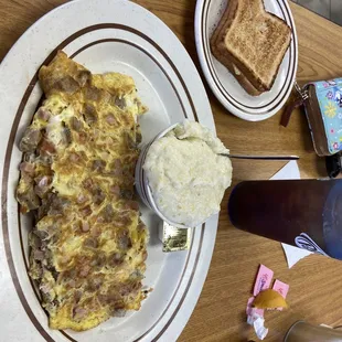 Meat lovers omlet with grits and toast