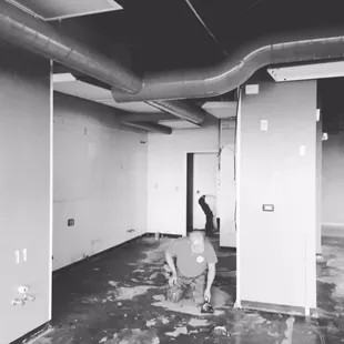 a black and white photo of a man working in a room