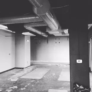 empty room with exposed pipes