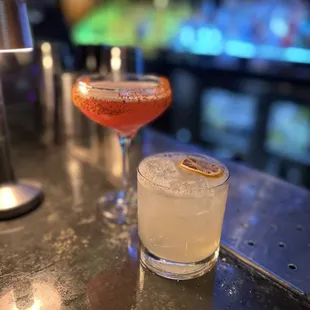 two cocktails on a bar