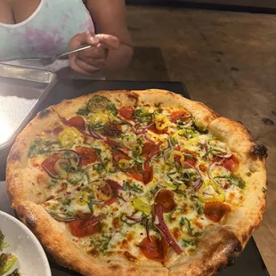 The Situation (pesto, pepperoni, salami, pepperoncini, red onion and basil)