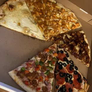 four slices of pizza in a box