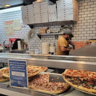 a man working in a pizza shop