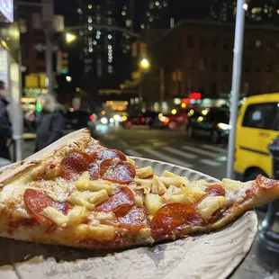a slice of pizza on a paper plate