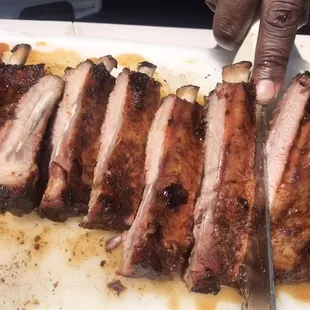a person cutting ribs