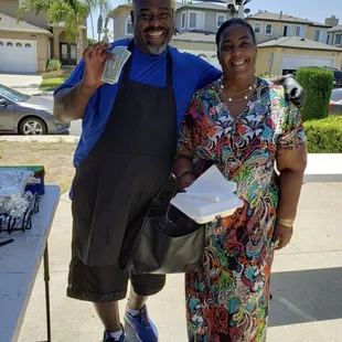 a man and a woman standing under a tent