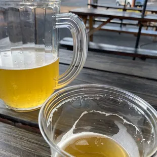 two glasses of beer on a picnic table