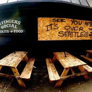 two wooden benches and a sign that says see you after it&apos;s over